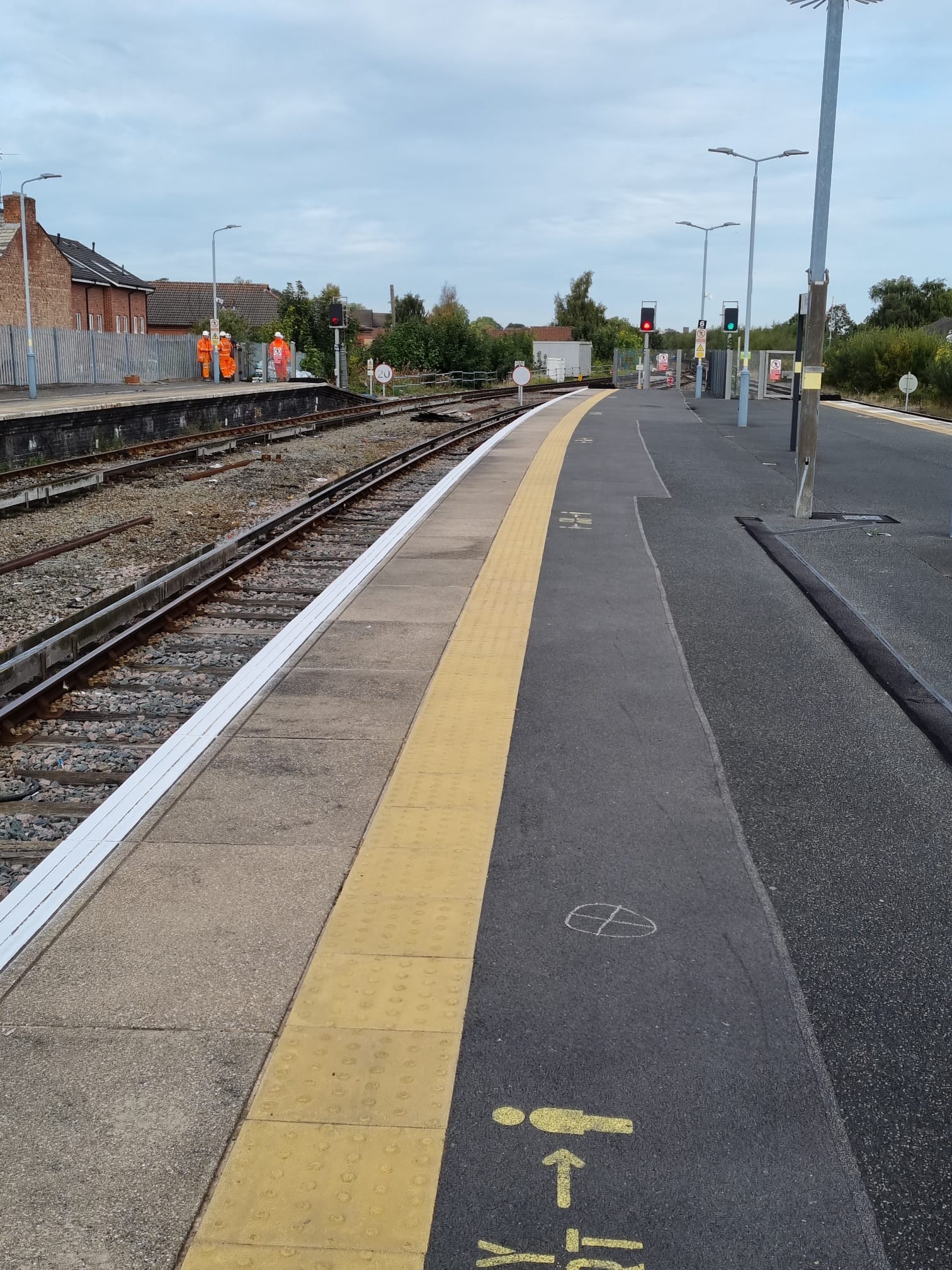 Empty railway station platform with tracks