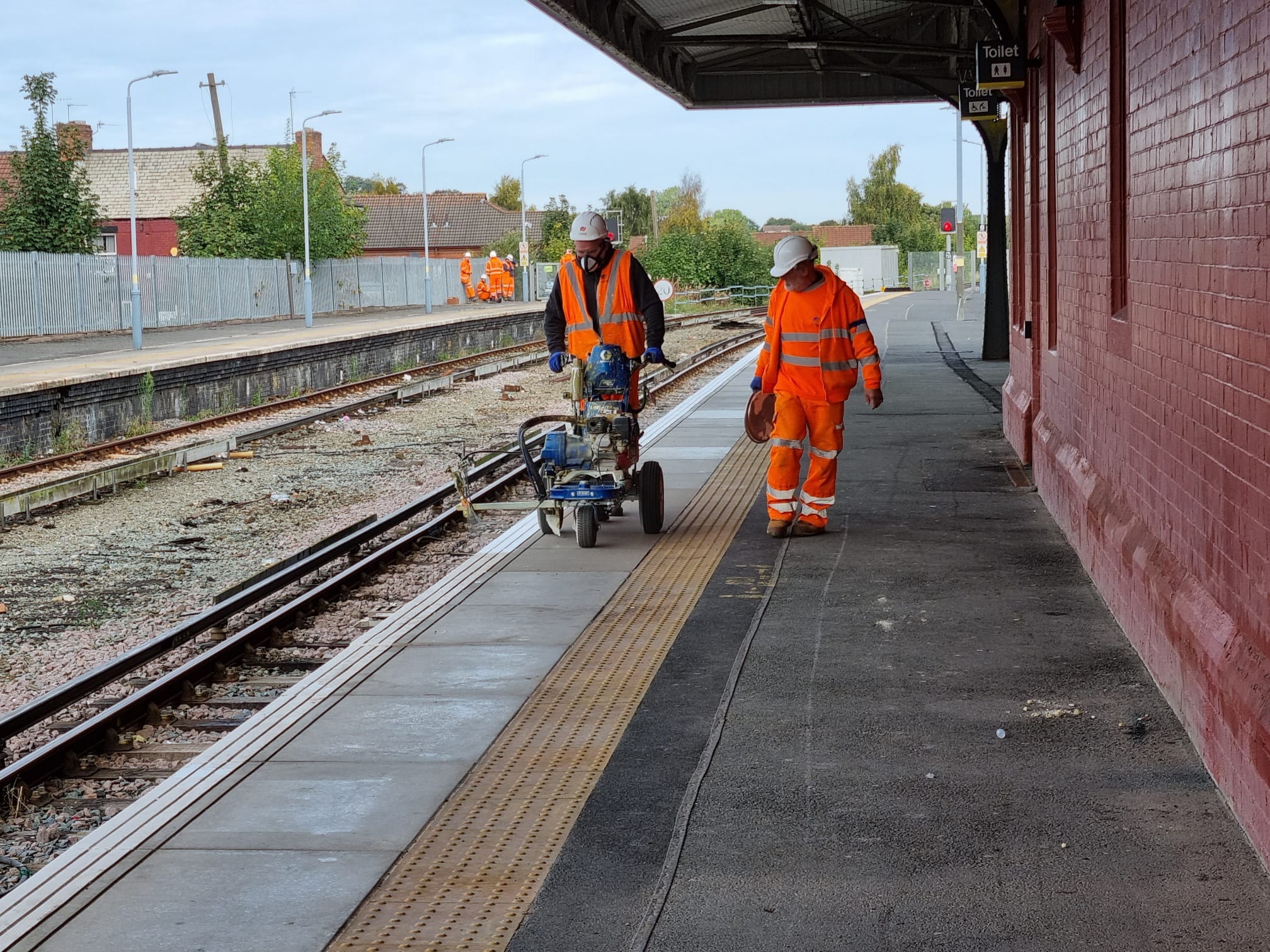 Railway workers maintaining train platform