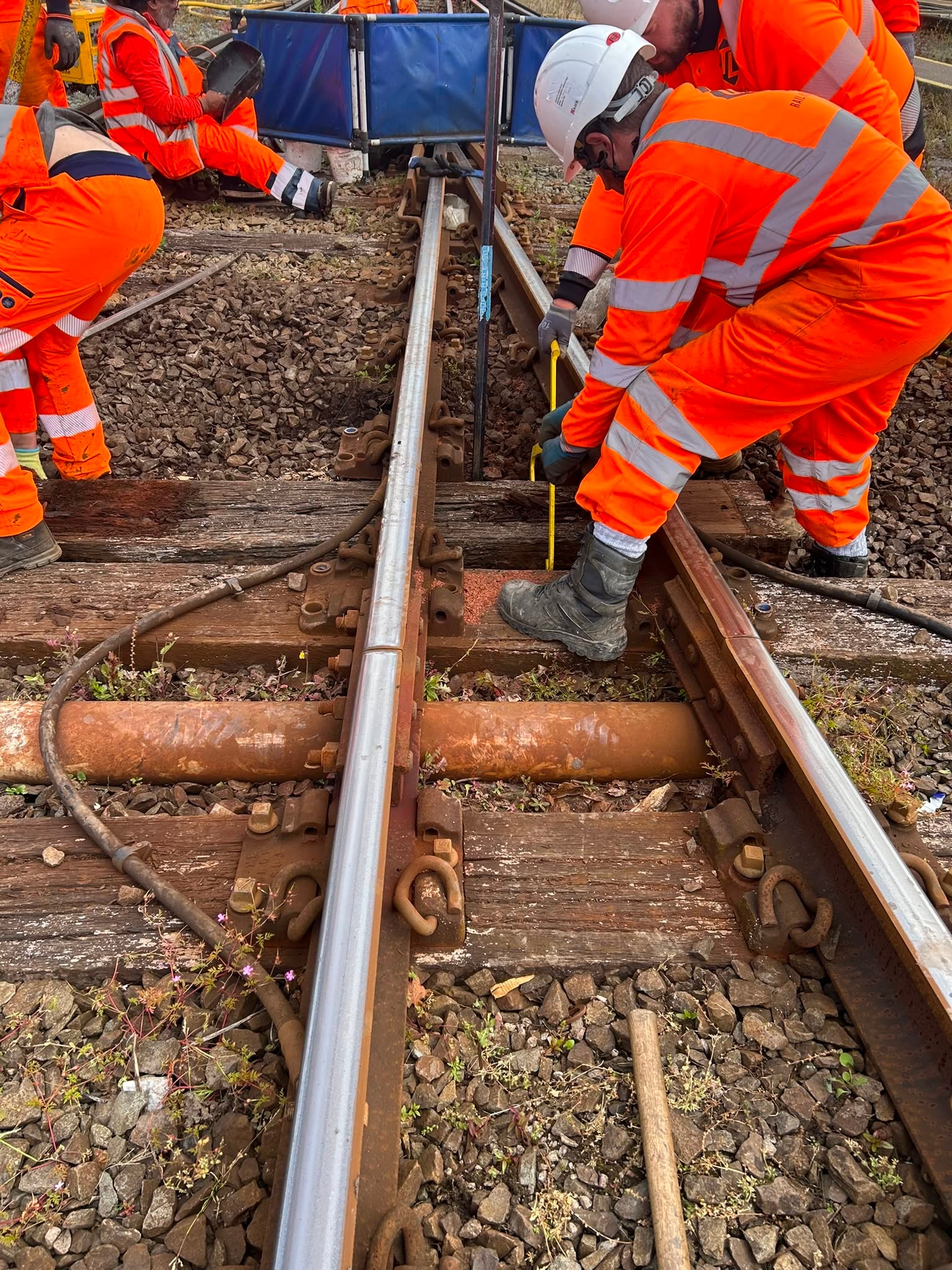 Construction workers maintaining railroad tracks