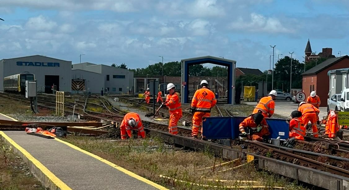 Railway workers maintaining tracks depot