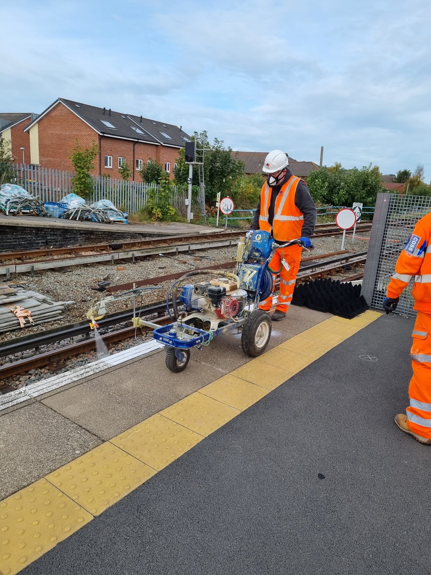 Railway worker operating track maintenance equipment