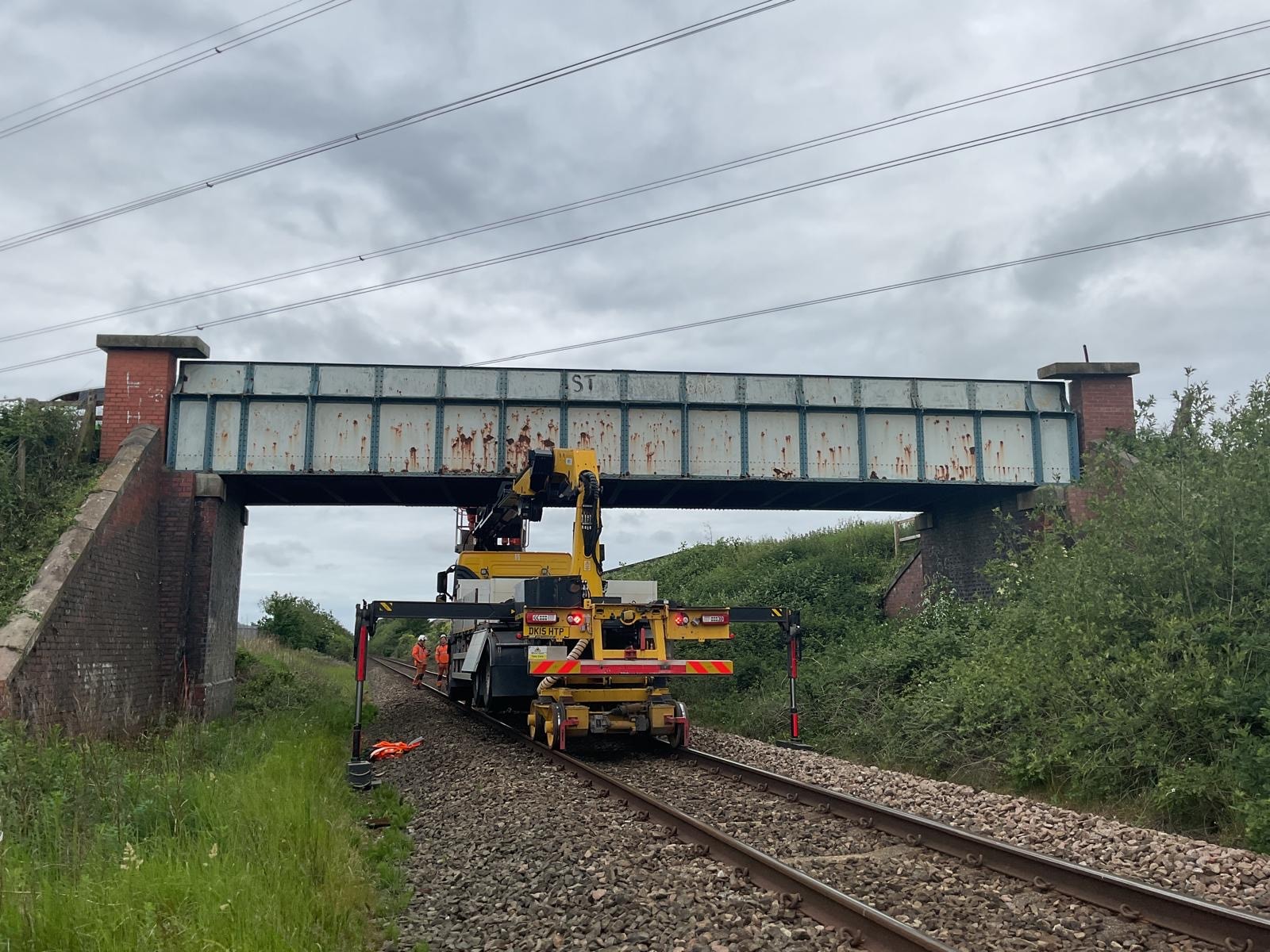 Railway maintenance crane under bridge
