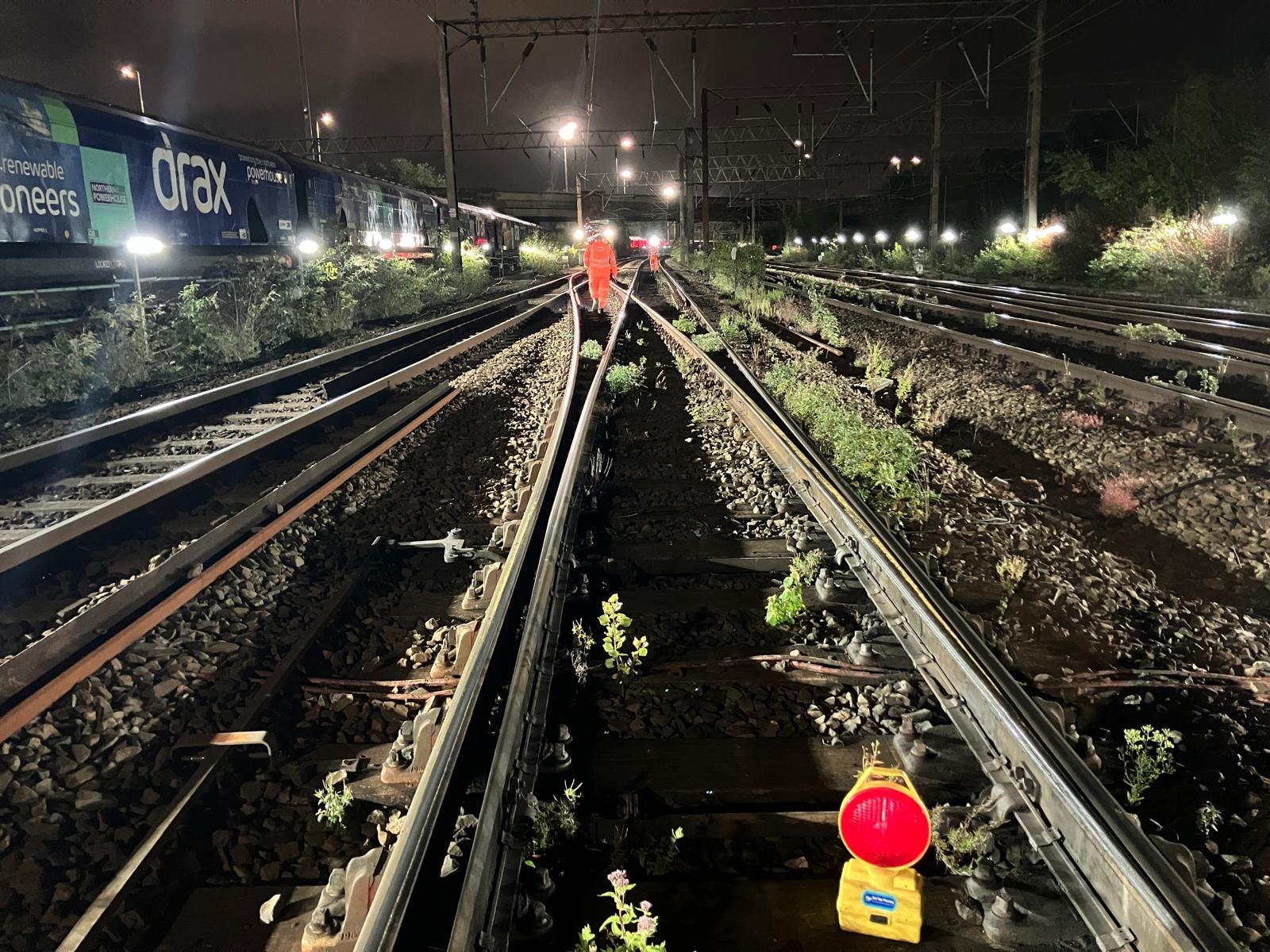 Railroad worker inspecting tracks at night