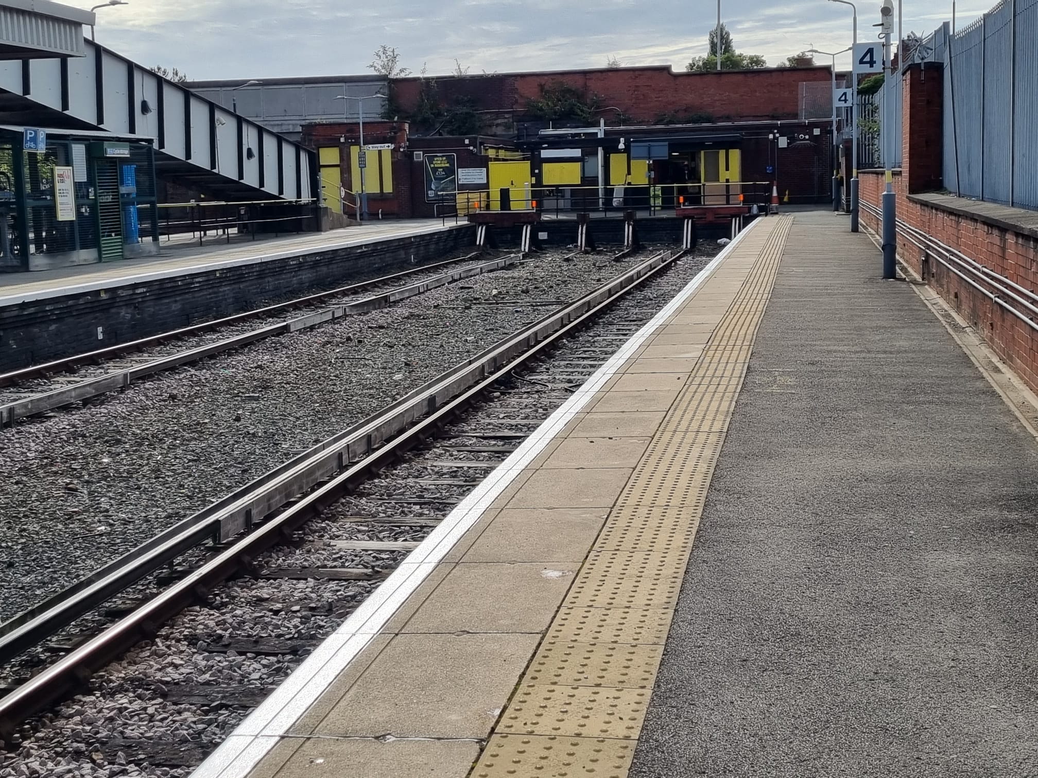 Empty railway station platform tracks