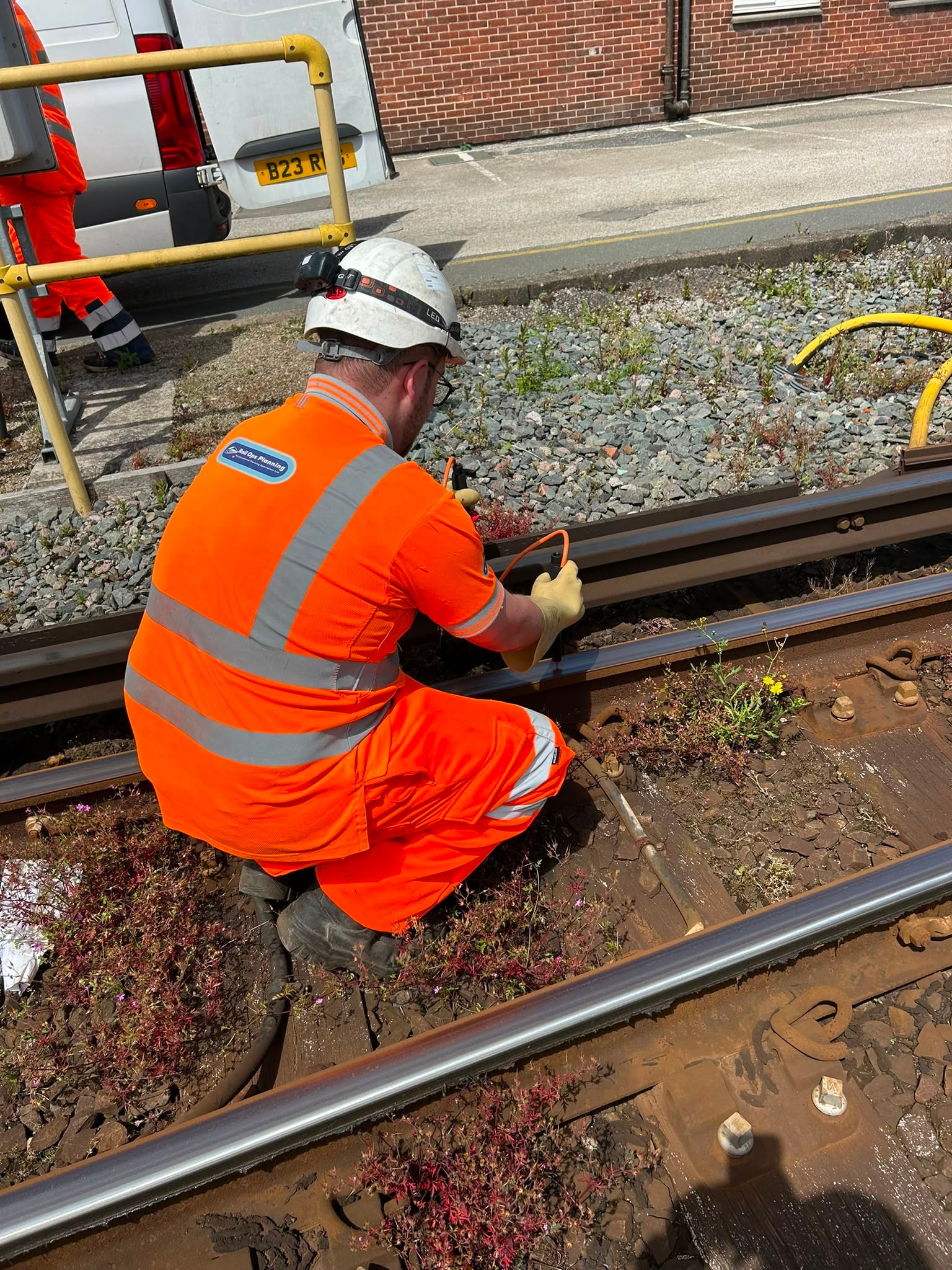 Construction worker inspecting railway tracks