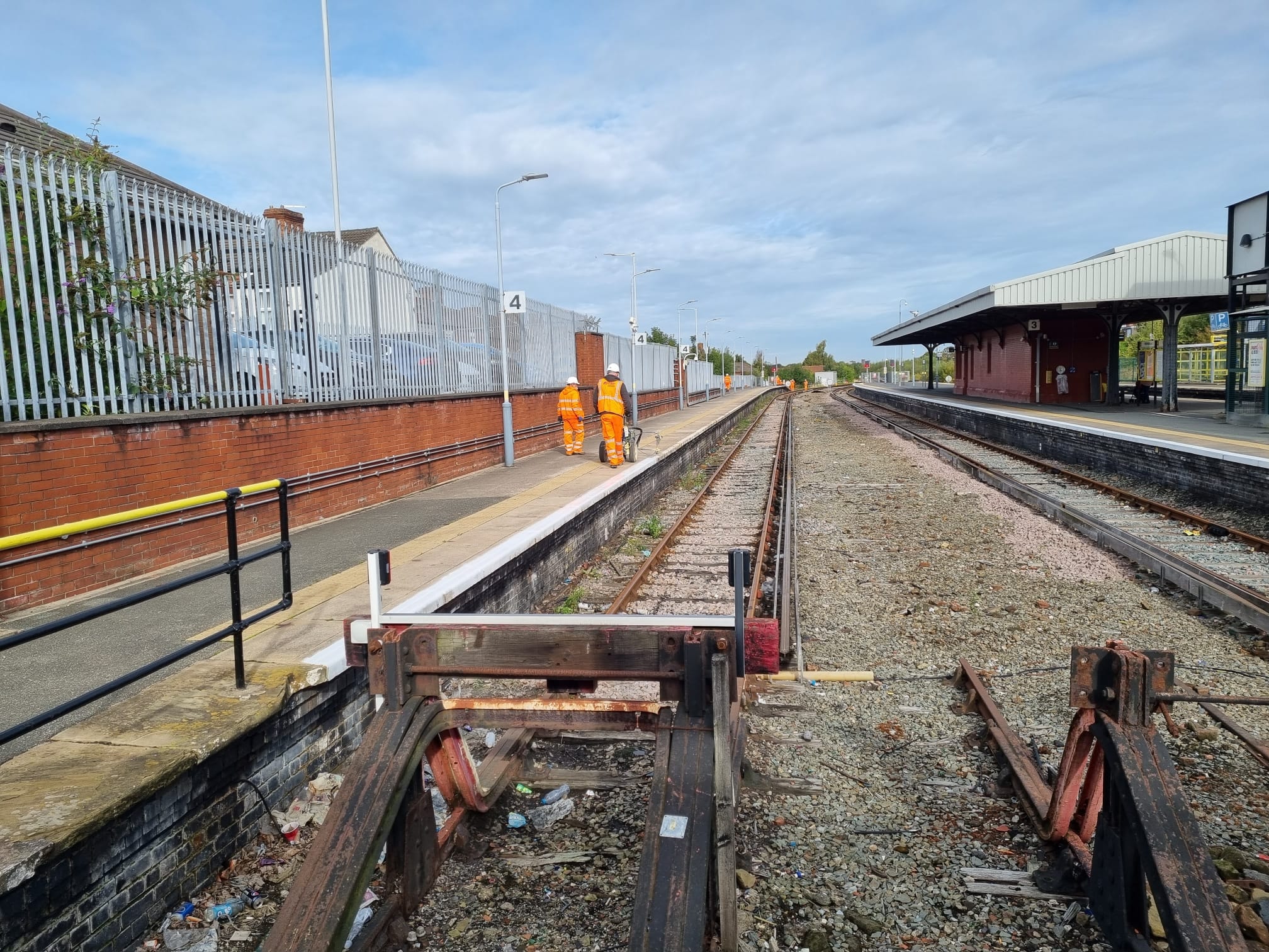 Railway station platform with workers