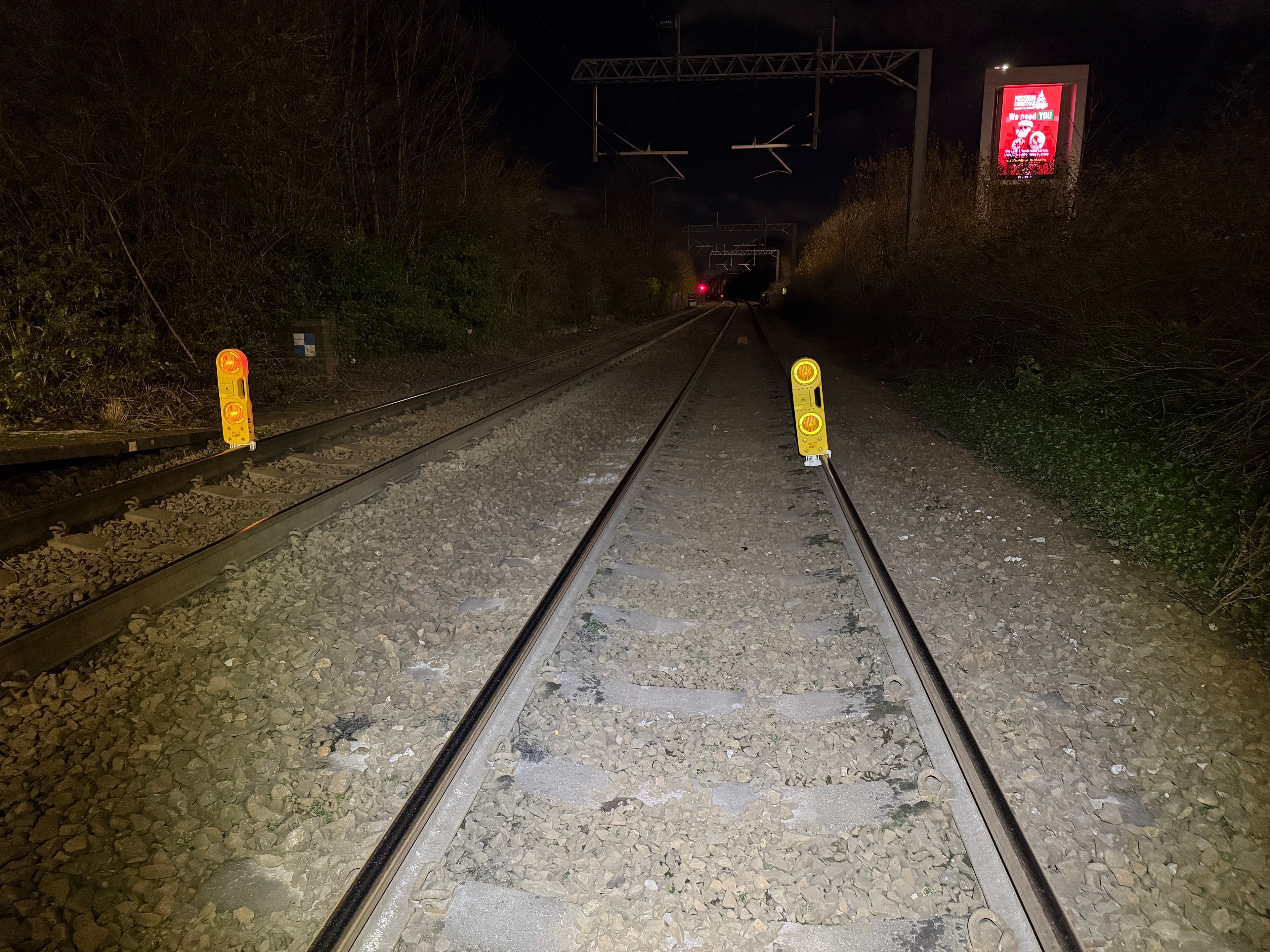 Railroad tracks at night with warning lights