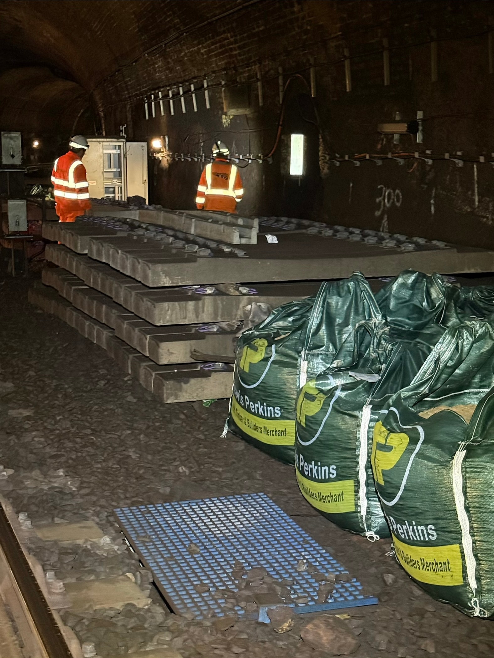 Workers inspecting underground tunnel