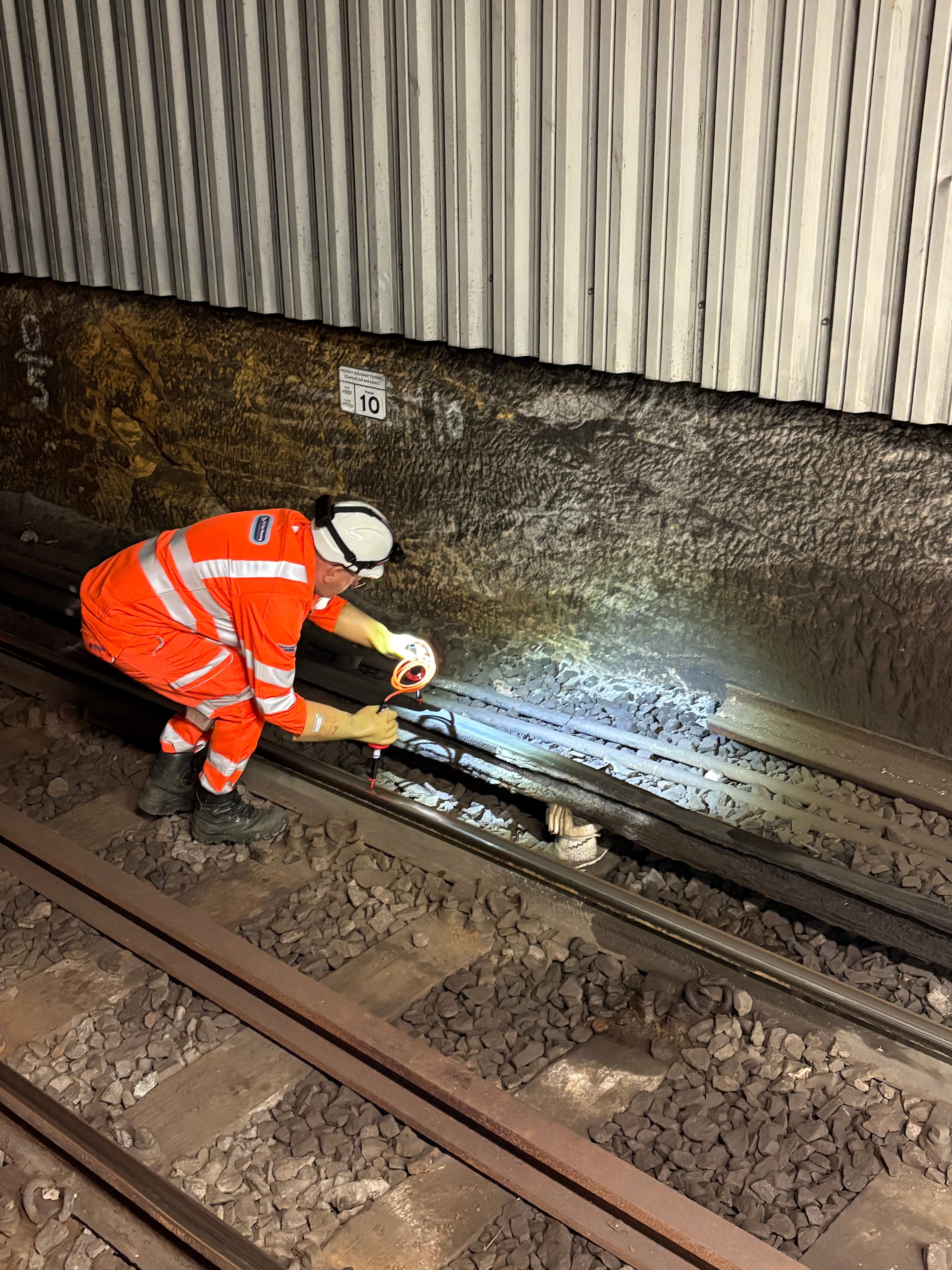 Worker inspecting railroad track maintenance