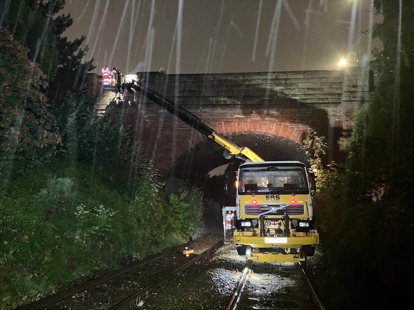 Emergency repair truck under railway bridge